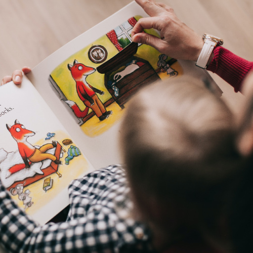 child reading picture book about a fox
