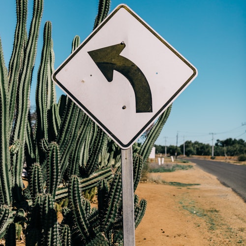 A road sign arrow pointing to the left.